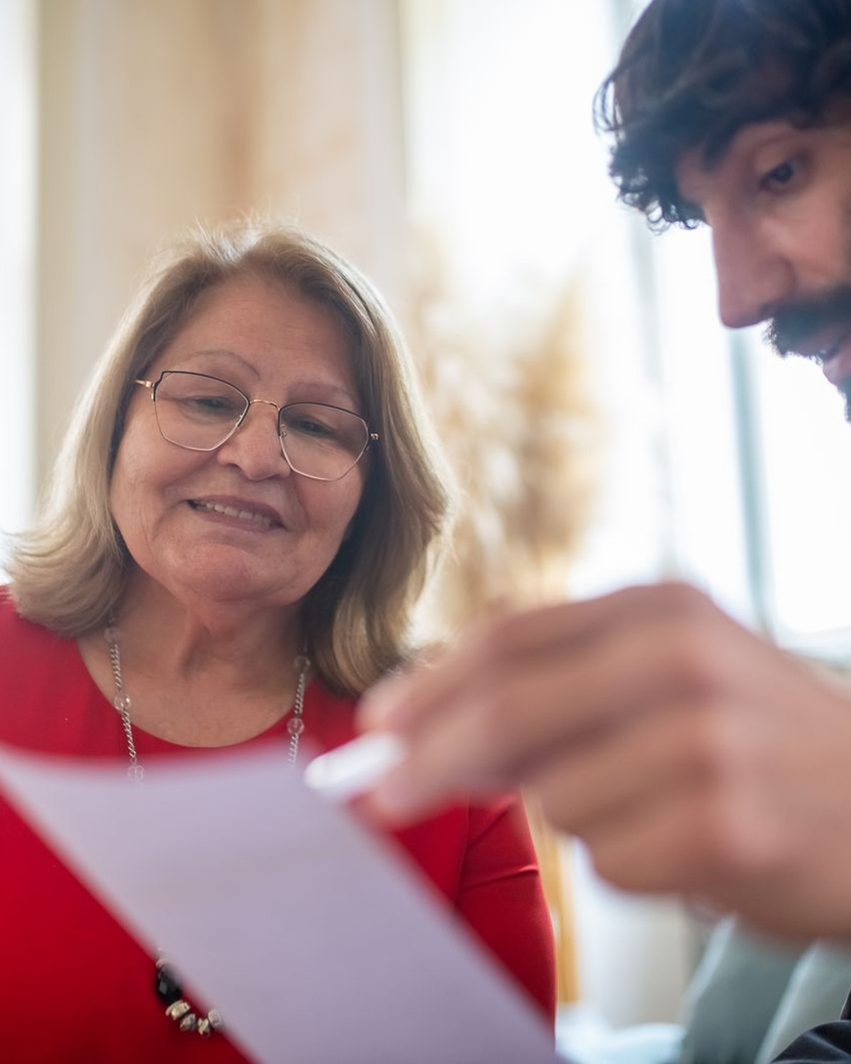 A male insurance adviser reviewing documents with an older client